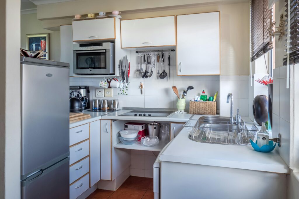 pexels-photo-1599791-1599791-1 Sophisticated kitchen interior with modern appliances, wooden accents, and functional design.